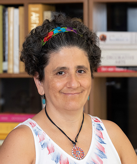 Headshot of Dr. Ana Maria del Rio Gonzalez with books in the background