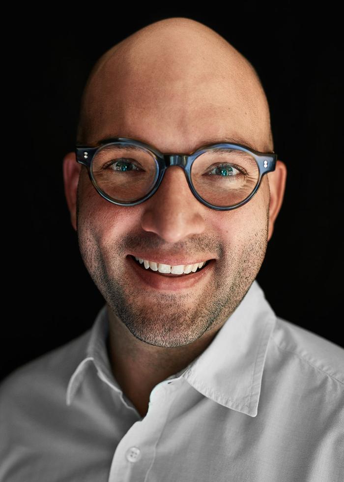 Headshot of Carlos Rodriguez-Diaz with a black background