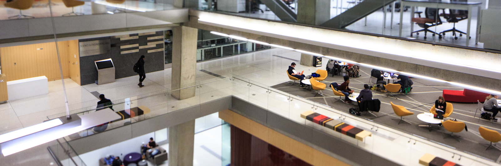 Image of building floor with students reading 